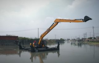 Amphibious excavators are used to clean up sediment in fish ponds